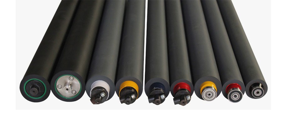 Close-up macro photography of multiple precision-ground industrial ink rollers arranged systematically. The rollers exhibit a smooth, uniform surface texture, reflecting crisp, high-key studio lighting that emphasizes manufacturing excellence. The color palette features stark industrial greys and blacks against a pristine white background, conveying a sense of sterile precision, modern tech-glow aesthetic, and high-quality fabrication.